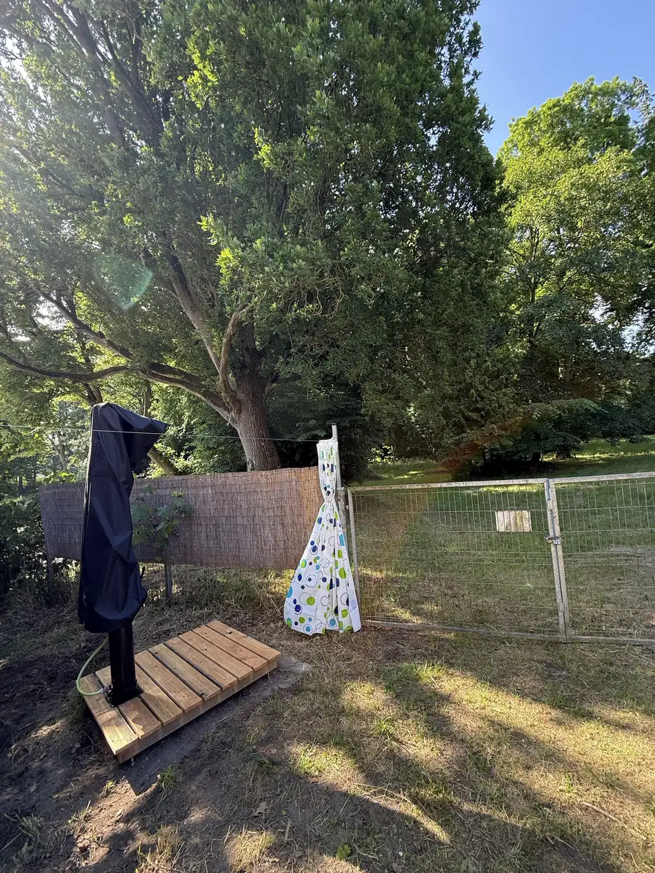 Solar shower with privacy screen by the wash house